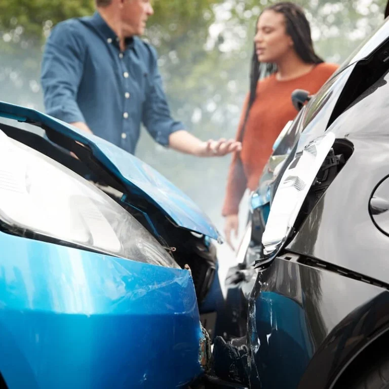 Two drivers discussing car accident damage in Peoria, IL